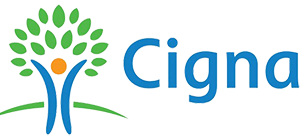 The image shows a logo with a stylized tree and a person s silhouette at the top, enclosed within a circular frame, with text above that reads Cigna in capital letters.
